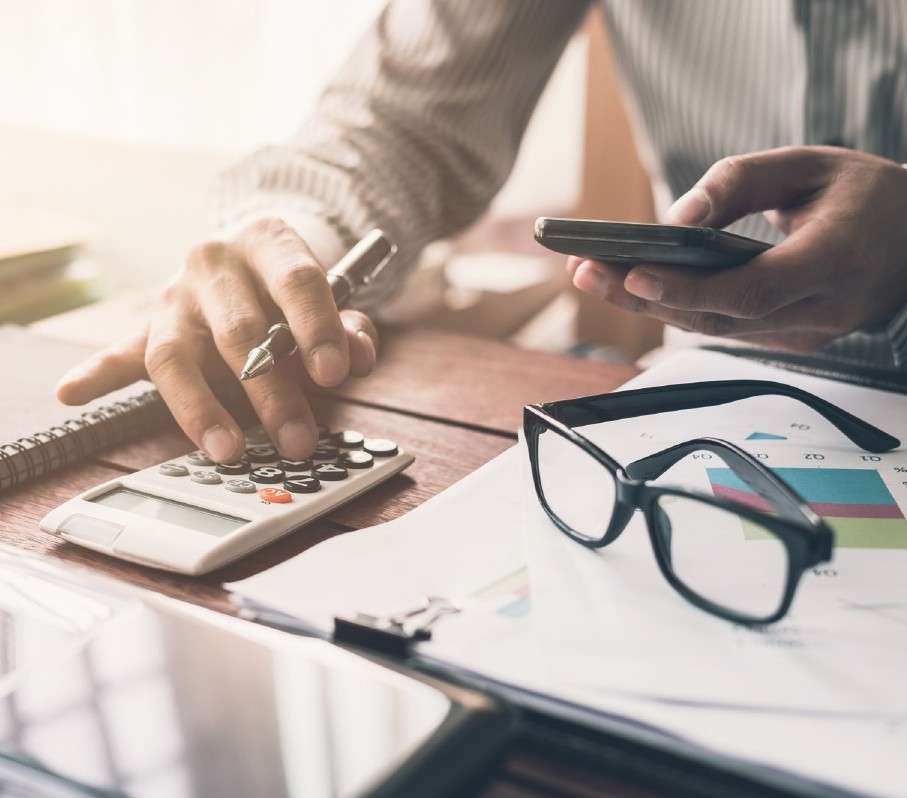 Close-up of a calculator and financial documents, representing accounting and bookkeeping services.